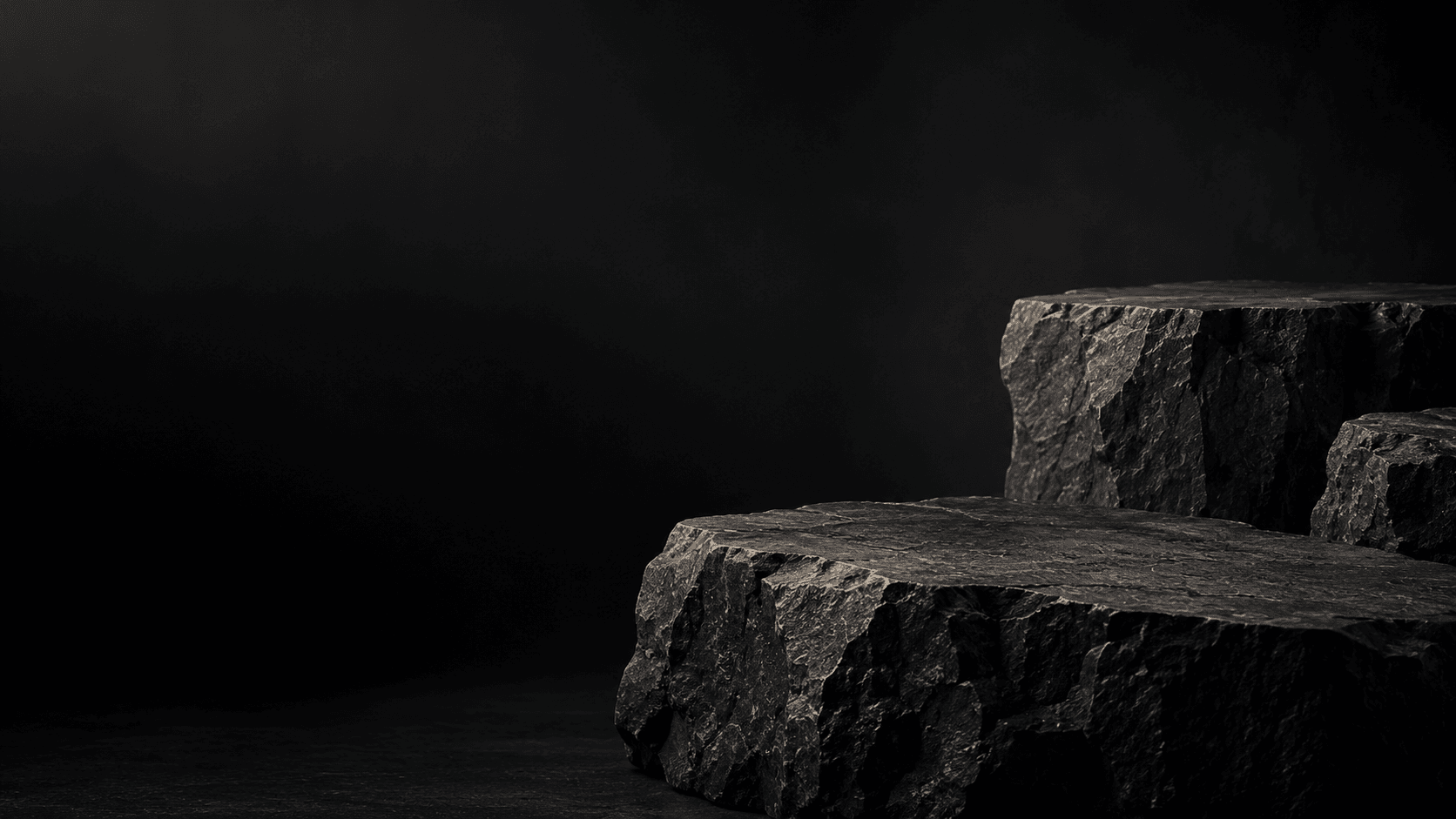 Dark stone plinths lit from the side